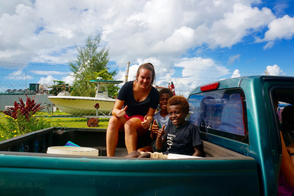 in the back of a truck on an island road trip in papua new guinea