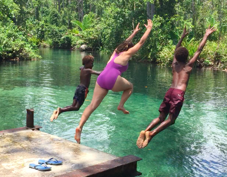 jump in the water on an island road trip in papua new guinea